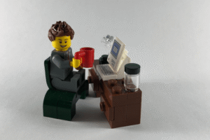 a man is sitting before computer screen to sell things